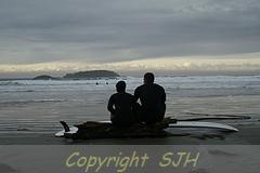 Surfers contemplating the next wave